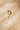 Side profile of an irregular gold textured band. The uneven silhouette and raw grain create a tactile, elemental character.