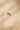 Irregular-shaped gold band with a heavily textured surface. Captured from a front angle to highlight the organic form and raw, hand-shaped detail.