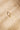 Top view of a handcrafted gold band featuring heavy texture across the surface. The uneven grain reflects light softly and naturally.